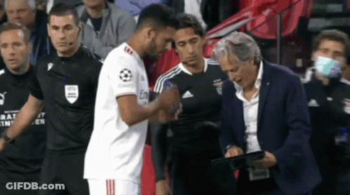 Man In Suit With Tablet Watching Soccer Handshake GIF