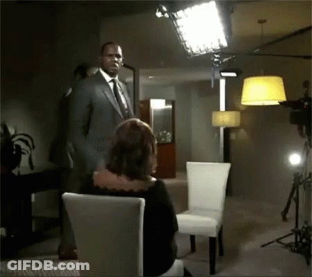 Man In Suit With Tie Before Woman In Chair GIF