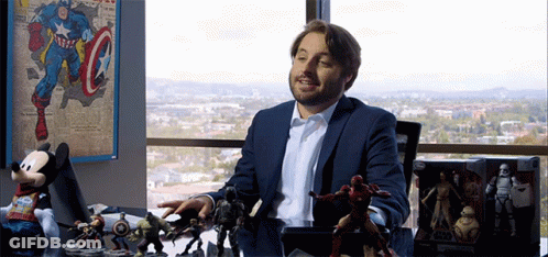 Man In Suit With Toys And Captain America Poster GIF