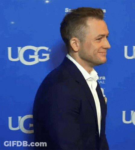 Man In Suit With UGG On Blue Background GIF