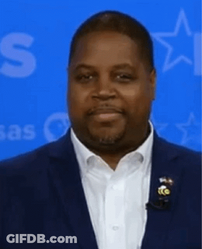 Man In Suit With White Shirt And Blue Star Background GIF