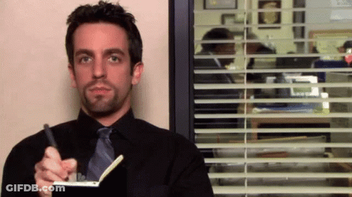 Man In Suit Writing In Notebook GIF