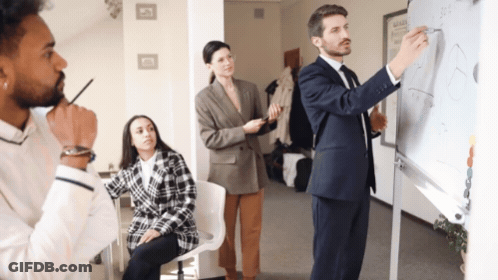 Man In Suit Writing On Whiteboard Woman Looking On GIF