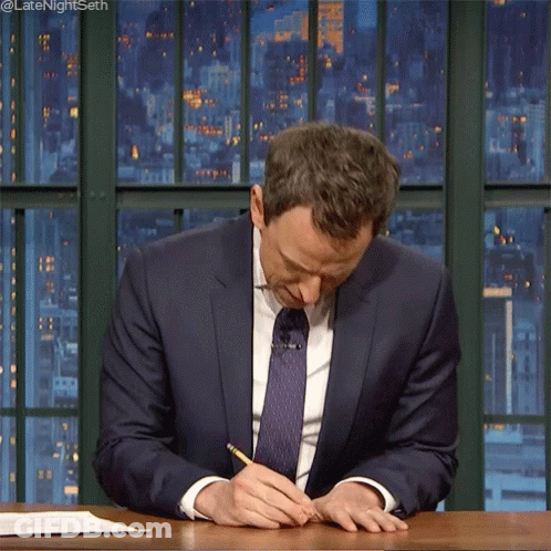 Man In Suit Writing With Pencil At Desk GIF