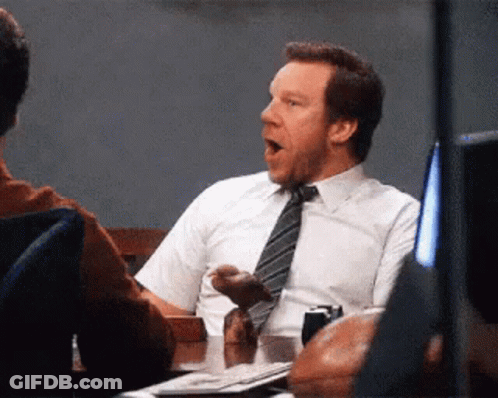 Man In Suit Yawning At Table GIF