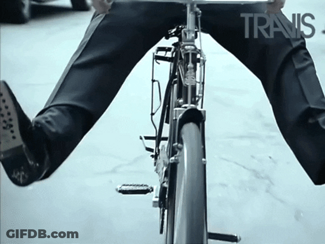 Man In Suits Riding Bike GIF