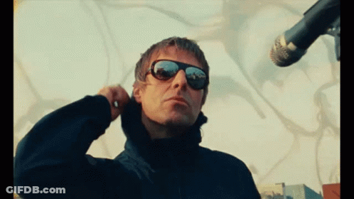 Man In Sunglasses Adjusts Ear Buds GIF