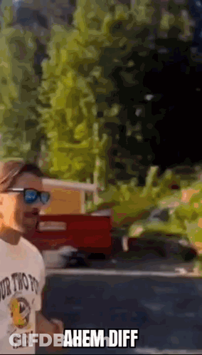 Man In Sunglasses And Ahem Diff T-Shirt In Front Of Red Truck GIF