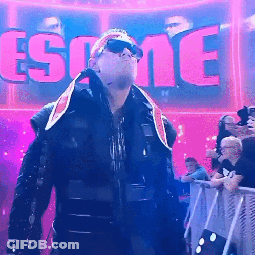 Man In Sunglasses And Bandana In Front Of Esome Sign GIF