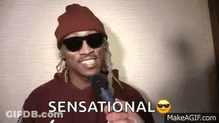 Man In Sunglasses And Beanie Holding Microphone Saying Sensational GIF