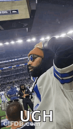 Man In Sunglasses And Beanie Says Ugh At Football Game GIF