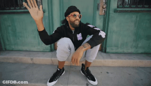 Man In Sunglasses And Beanie Sitting By Door GIF