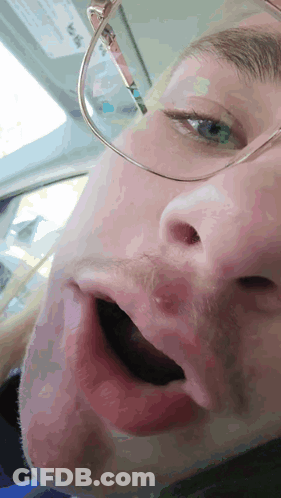 Man In Sunglasses And Beanie Sitting By Door GIF