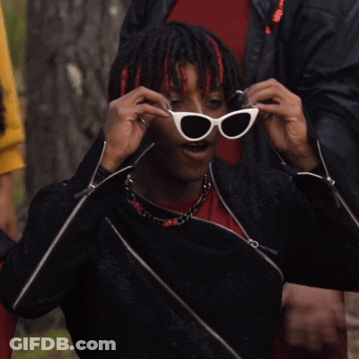 Man In Sunglasses And Black Jacket Adjusting Glasses GIF