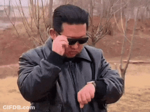 Man In Sunglasses And Black Jacket Checking Watch GIF
