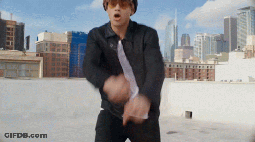 Man In Sunglasses And Black Jacket Dancing On Rooftop GIF