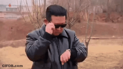 Man In Sunglasses And Black Jacket Looking At Watch GIF