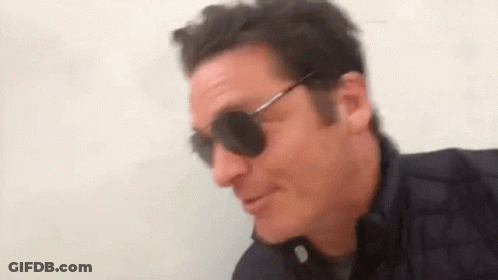 Man In Sunglasses And Black Jacket Smiling GIF