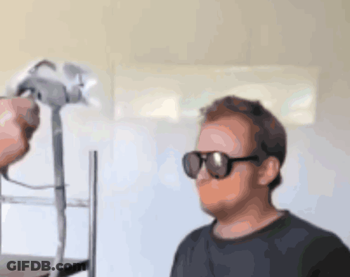 Man In Sunglasses And Black Shirt Being Photographed GIF