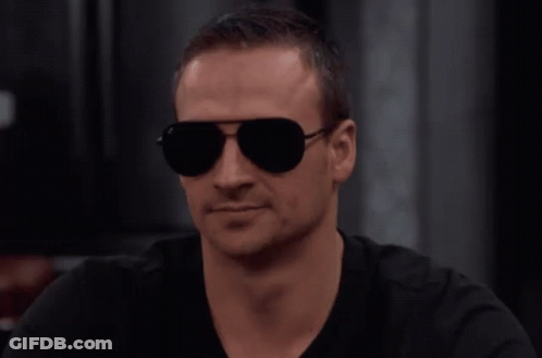 Man In Sunglasses And Black Shirt Looks Serious GIF