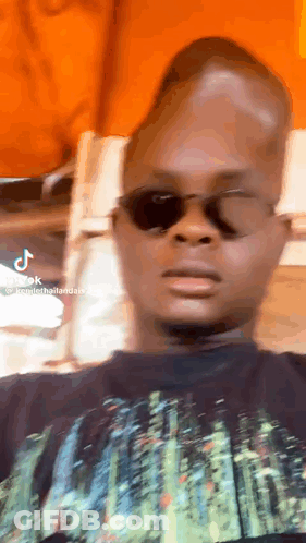 Man In Sunglasses And Black Shirt Making Funny Face GIF