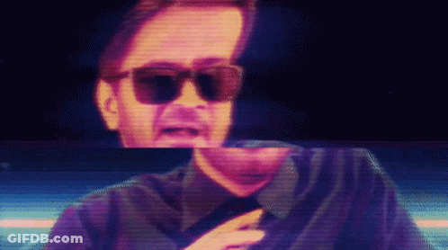 Man In Sunglasses And Black Shirt On Screen GIF