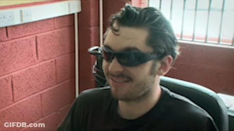 Man In Sunglasses And Black Shirt Smiling GIF