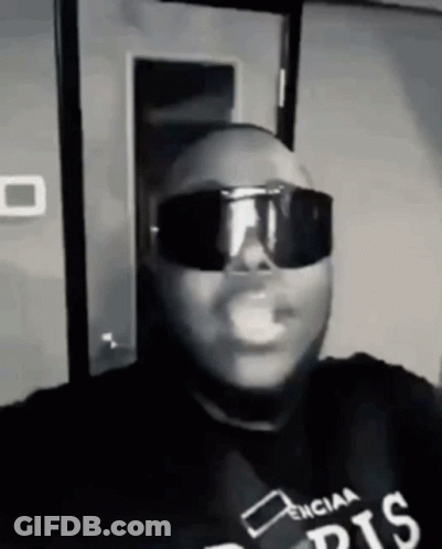 Man In Sunglasses And Black Shirt Smoking Black And White GIF