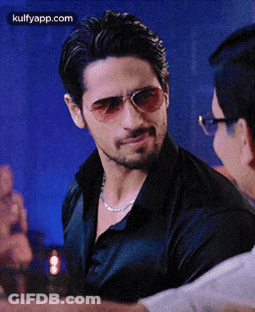 Man In Sunglasses And Black Shirt Talking GIF
