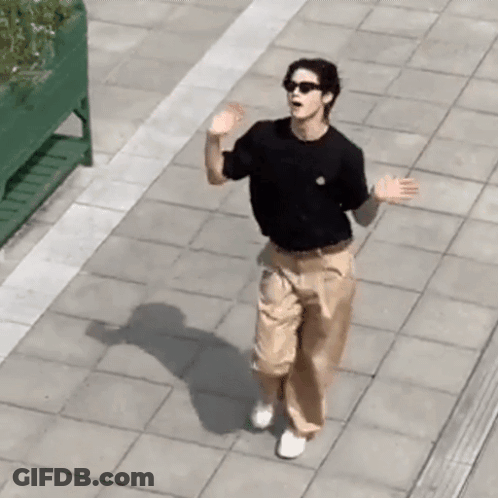Man In Sunglasses And Black Shirt Walking GIF