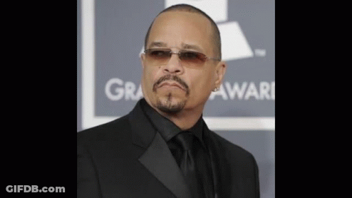 Man In Sunglasses And Black Suit In Front Of Grammy Sign GIF