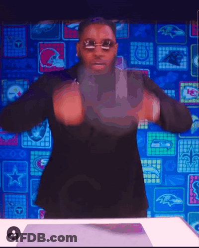 Man In Sunglasses And Black Suit In Front Of NFL Logos GIF