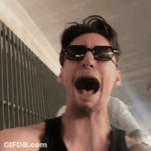 Man In Sunglasses And Black Tank Top Making Funny Face GIF