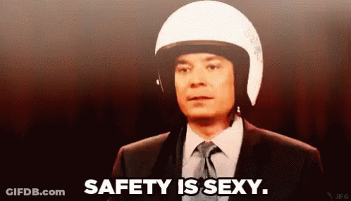 Man In Sunglasses And Black Tank Top Walking Down Hallway GIF