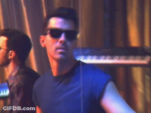Man In Sunglasses And Blue Shirt At Keyboard GIF