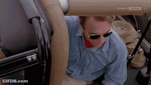 Man In Sunglasses And Blue Shirt In Car With Canal 4 Film HD GIF