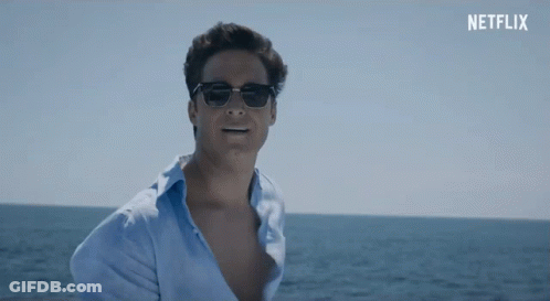 Man In Sunglasses And Blue Shirt In Front Of Netflix Banner GIF