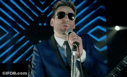 Man In Sunglasses And Blue Suit Singing GIF