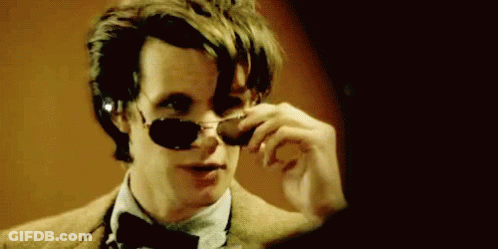 Man In Sunglasses And Bow Tie Looking In Mirror GIF