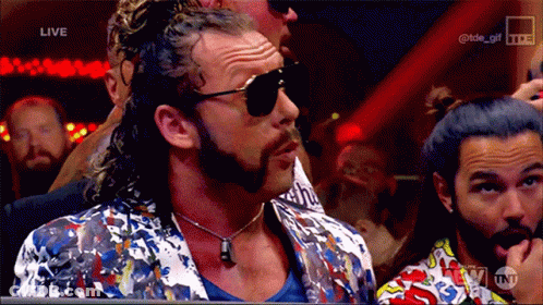Man In Sunglasses And Colorful Jacket Watching Wrestling GIF