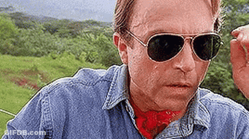 Man In Sunglasses And Denim Shirt In Field GIF