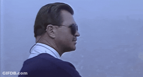 Man In Sunglasses And Earpiece Looking To Side GIF