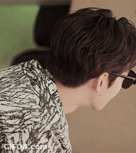 Man In Sunglasses And Earrings Looking Down GIF