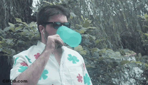Man In Sunglasses And Flower Shirt Drinking From Blue Cup GIF