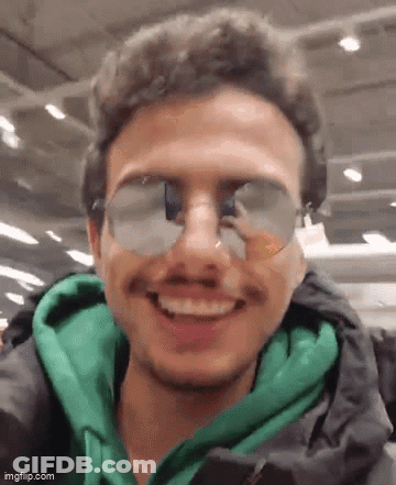 Man In Sunglasses And Green Jacket Smiling GIF