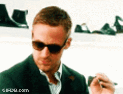 Man In Sunglasses And Green Suit Smoking GIF