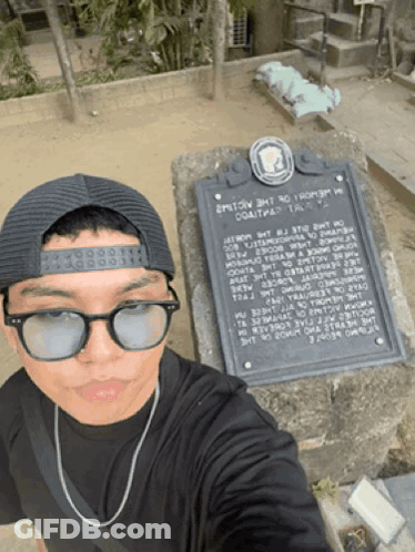 Man In Sunglasses And Hat At Historical Monument GIF