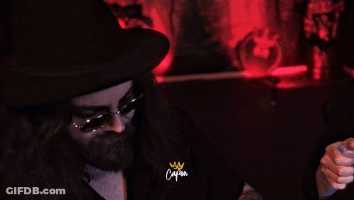 Man In Sunglasses And Hat Holding Watch With Captain Sign GIF