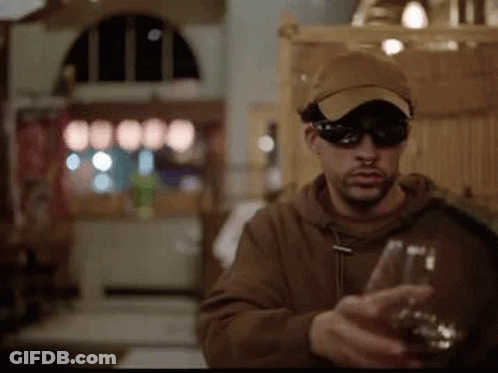 Man In Sunglasses And Hat Holding Wine GIF