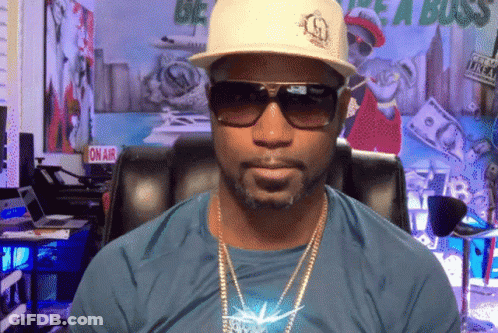 Man In Sunglasses And Hat In Front Of On Air Sign GIF